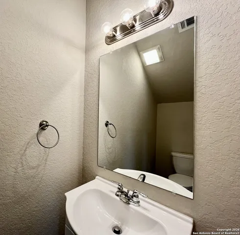 a bathroom with a sink and mirror