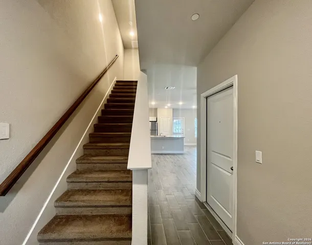 a view of entryway and gallery with wooden floor