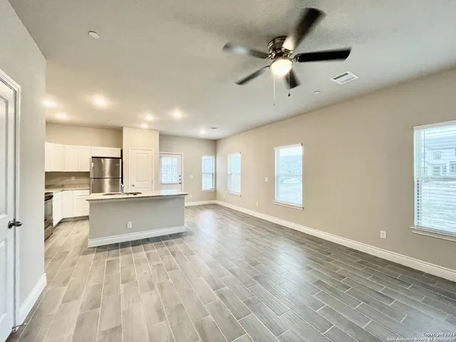 a view of kitchen with sink and window