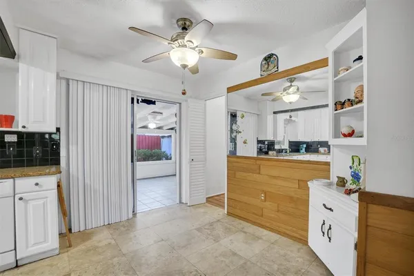 a kitchen with stainless steel appliances granite countertop a refrigerator a stove a sink a oven and white cabinets