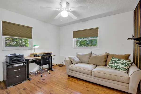 a bathroom with a granite countertop sink a toilet a mirror a vanity a bathtub and shower