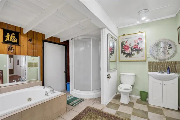 a view of a livingroom with wooden floor and a ceiling fan