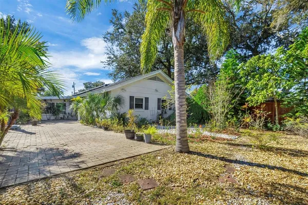 an aerial view of a house with a yard and large trees