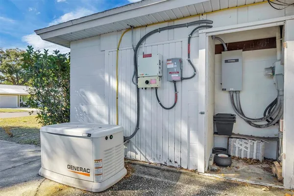 a view of an empty room with wooden floor and a ceiling fan