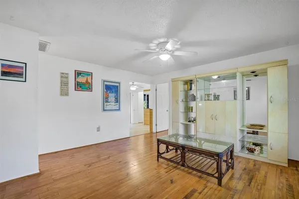 a living room with wooden floor and window