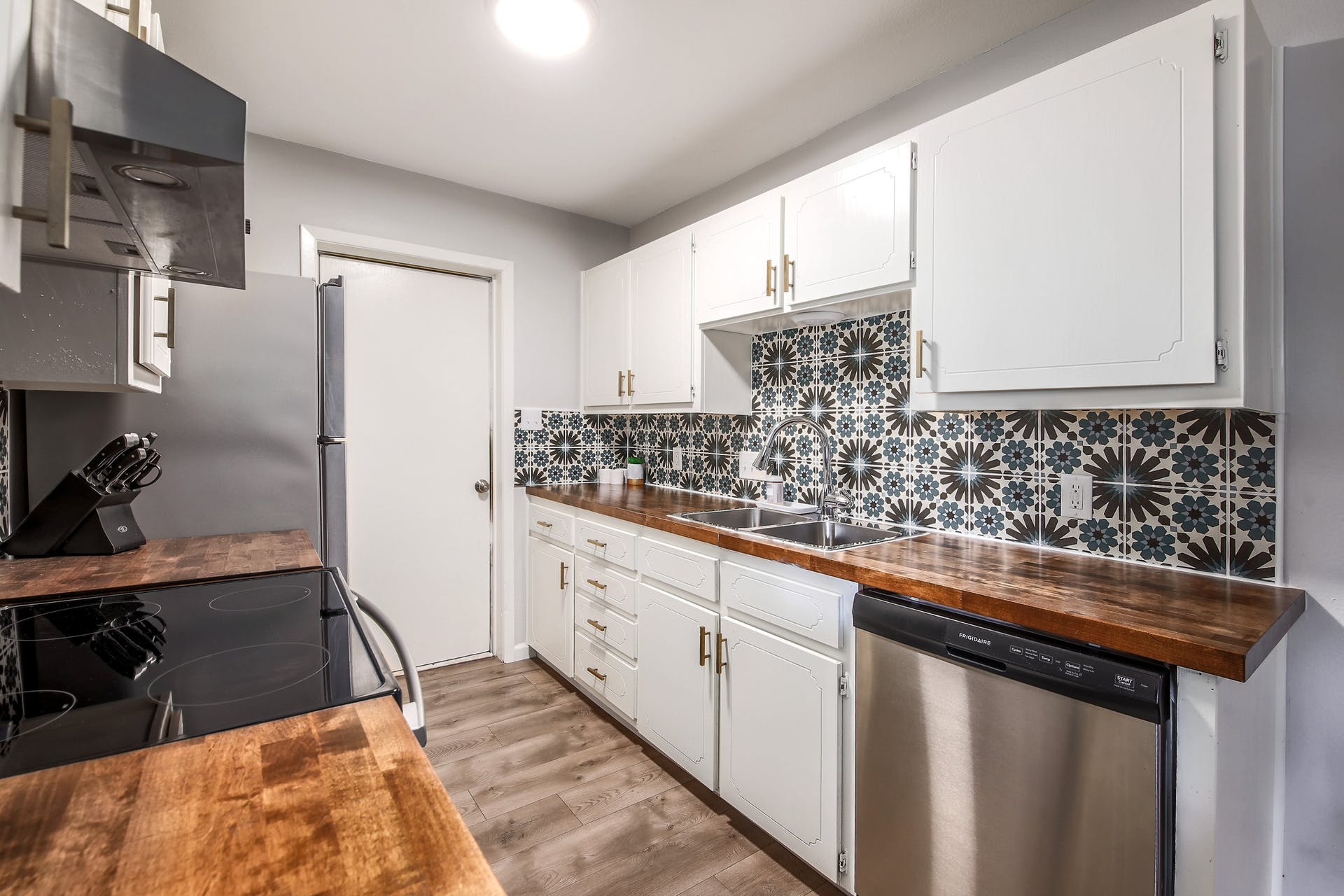 11118 Wandering Way, Unit A Austin, TX 78754 - Photo 13 of 29 a kitchen with granite countertop a sink a stove and cabinets