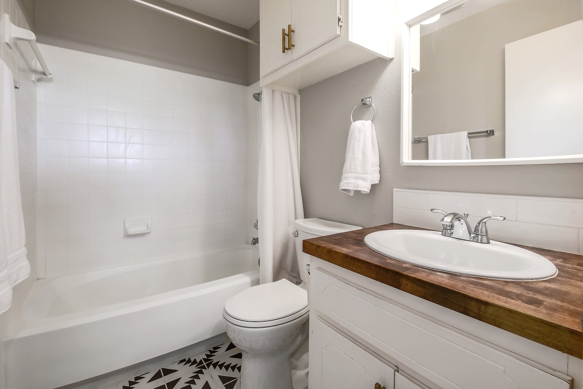 11118 Wandering Way, Unit A Austin, TX 78754 - Photo 26 of 29 a bathroom with a granite countertop sink mirror vanity and toilet
