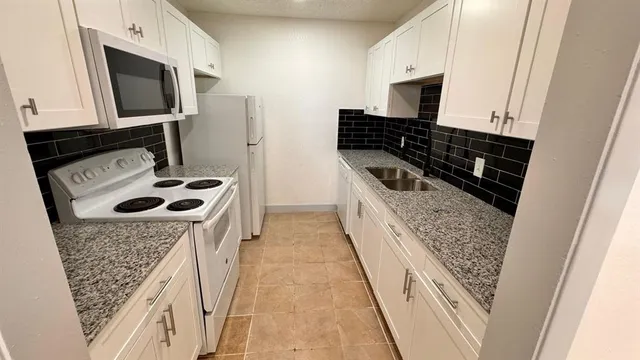 a kitchen with a stove and a microwave