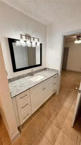 a bathroom with a sink a vanity and a mirror