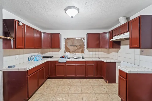 a kitchen with stainless steel appliances granite countertop wooden cabinets a sink and dishwasher