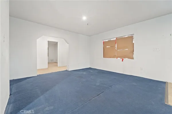 an empty room with windows and closet