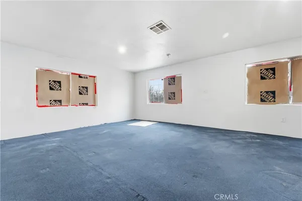 a view of an empty room with a painting on the wall