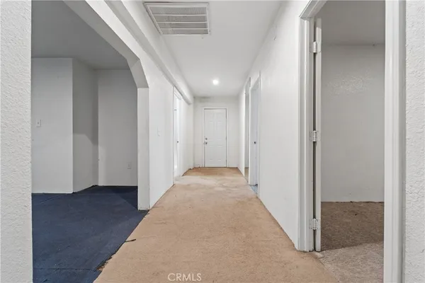en view of a hallway with wooden floor