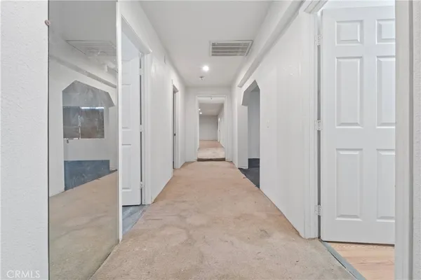 en view of a hallway with wooden shelves