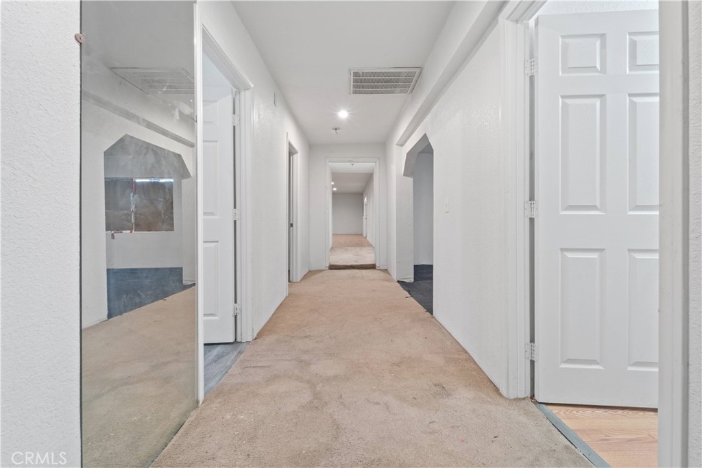 32900 Dune Road Newberry Springs, CA 92365 - Photo 18 of 40 en view of a hallway with wooden shelves