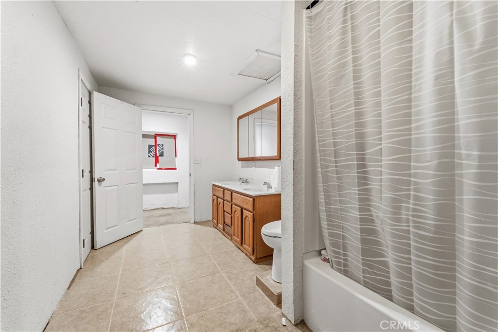 32900 Dune Road Newberry Springs, CA 92365 - Photo 21 of 40 a bathroom with a sink a toilet and shower
