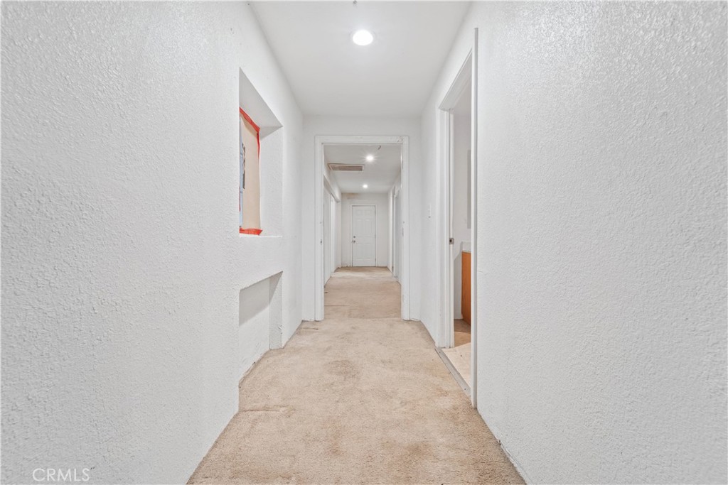 32900 Dune Road Newberry Springs, CA 92365 - Photo 23 of 40 a view of a hallway with wooden floor and a bathroom