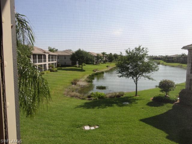 755 Regency Reserve Circle, Unit 5004 Naples, FL 34119 - Photo 1 of 24 a view of a garden with a lake