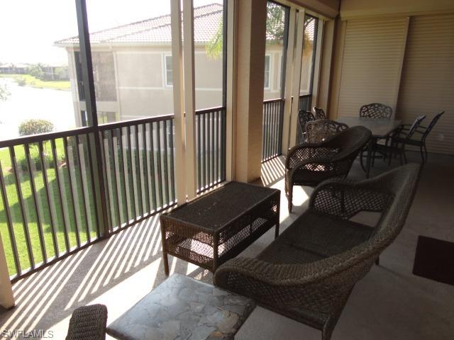 755 Regency Reserve Circle, Unit 5004 Naples, FL 34119 - Photo 12 of 24 a view of a balcony with chairs