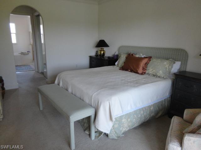 755 Regency Reserve Circle, Unit 5004 Naples, FL 34119 - Photo 15 of 24 a bedroom with bed and window