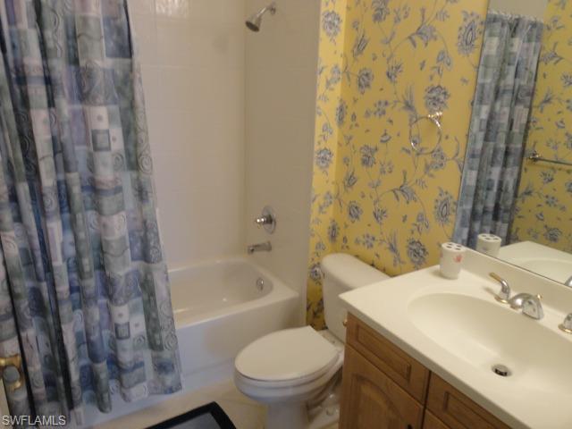 755 Regency Reserve Circle, Unit 5004 Naples, FL 34119 - Photo 19 of 24 a bathroom with a sink toilet and shower