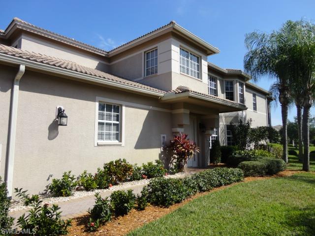 755 Regency Reserve Circle, Unit 5004 Naples, FL 34119 - Photo 2 of 24 a front view of a house with a porch