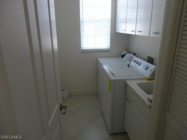 755 Regency Reserve Circle, Unit 5004 Naples, FL 34119 - Photo 23 of 24 a utility room with a window dryer and washer