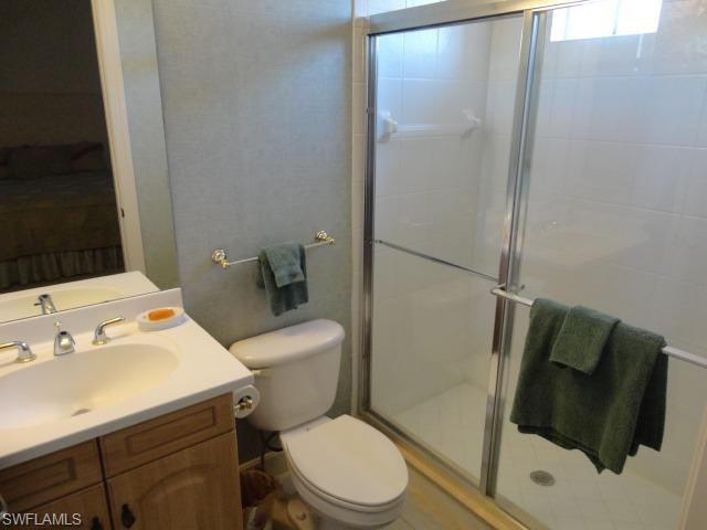 755 Regency Reserve Circle, Unit 5004 Naples, FL 34119 - Photo 24 of 24 a white toilet sitting next to a bathroom sink
