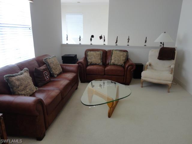 755 Regency Reserve Circle, Unit 5004 Naples, FL 34119 - Photo 3 of 24 a living room with furniture and a window