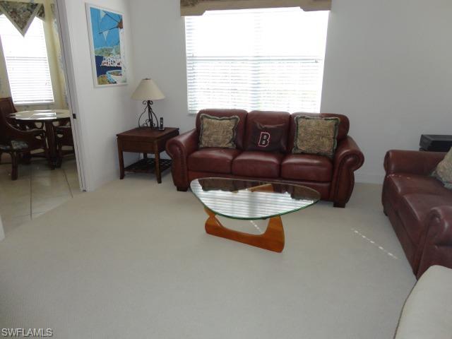 755 Regency Reserve Circle, Unit 5004 Naples, FL 34119 - Photo 4 of 24 a living room with furniture and a window
