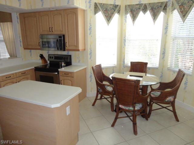 755 Regency Reserve Circle, Unit 5004 Naples, FL 34119 - Photo 6 of 24 a view of a dining room with furniture window and outside view
