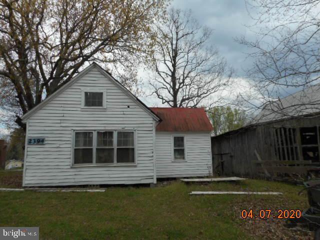 6255 Butler Road St. Leonard, MD 20685 - Photo 4 of 15 a front view of a house with a garden