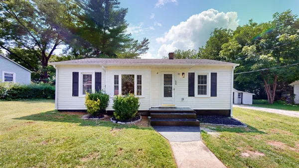 a front view of house with yard and green space