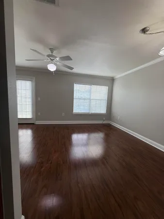 wooden floor in an empty room with a window