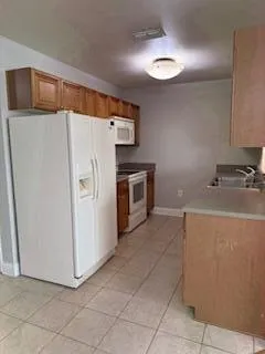 a utility room with cabinets washer and dryer