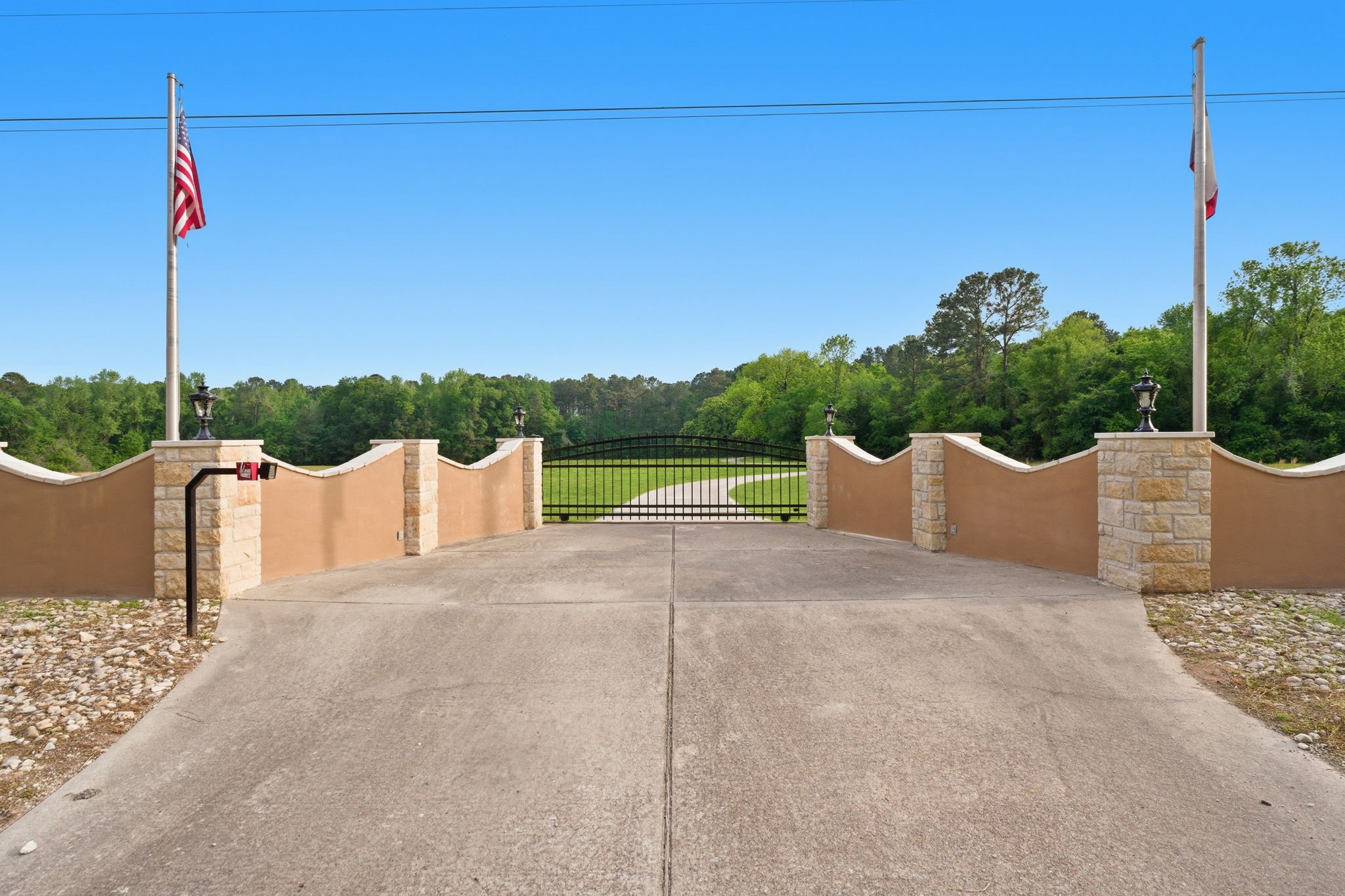 43 Pool Road Richards, TX 77873 - Photo 3 of 50 Enter the estate through the private gated entrance. There is a second gated entrance about 50 yards past this one on the same road. The paved drive winds through a wooded buffer which ensures your privacy. Ideal for a family estate or corporate retreat.