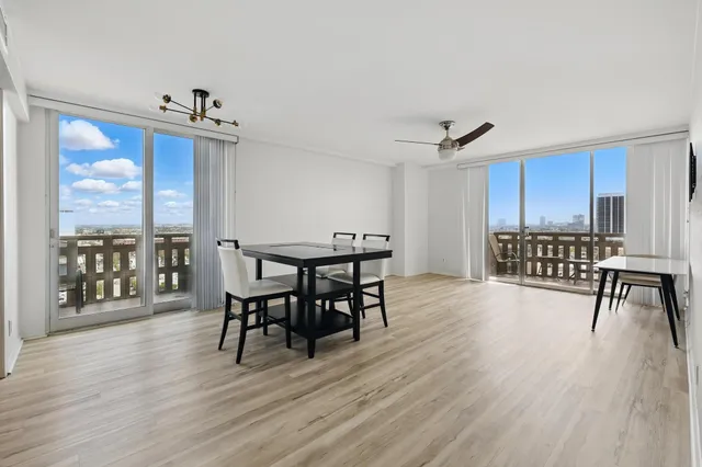 a view of a dining room with furniture window and wooden floor
