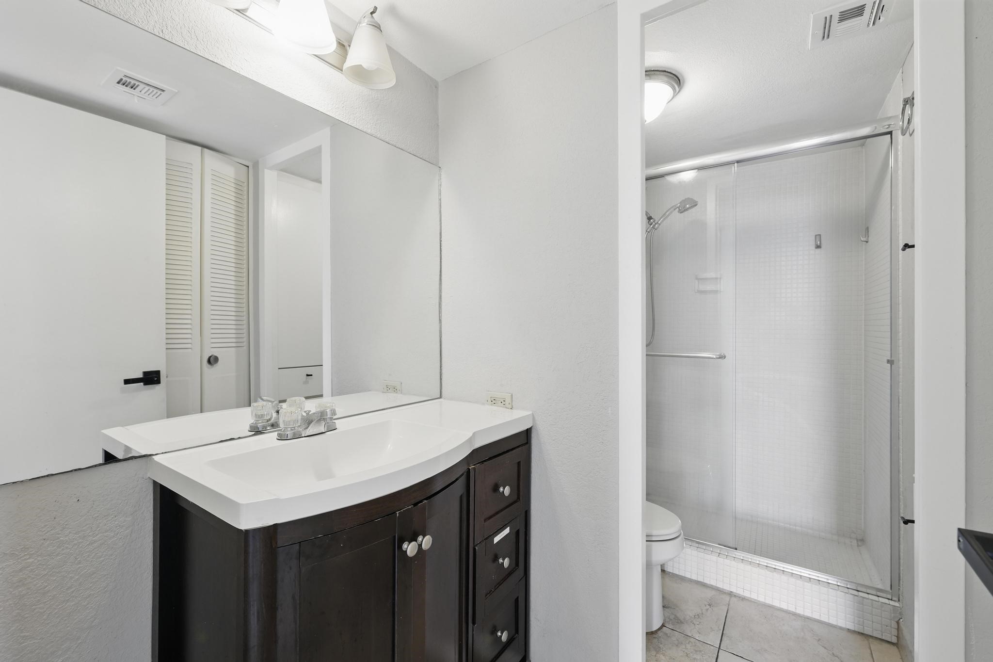 2016 Main Street, Unit 1502 Houston, TX 77002 - Photo 11 of 20 a bathroom with a sink toilet and shower