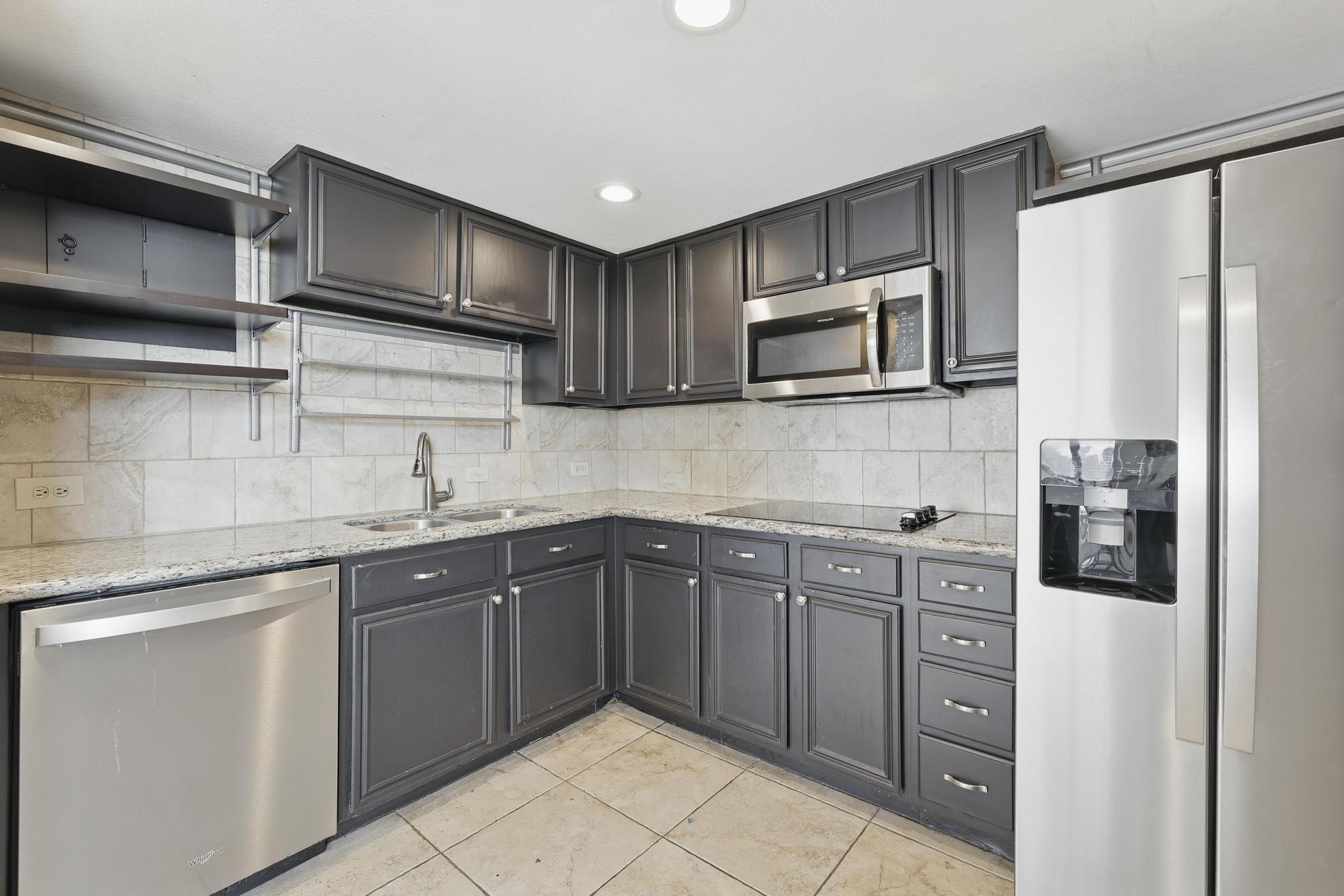 2016 Main Street, Unit 1502 Houston, TX 77002 - Photo 2 of 20 a kitchen with stainless steel appliances granite countertop a sink stove and refrigerator