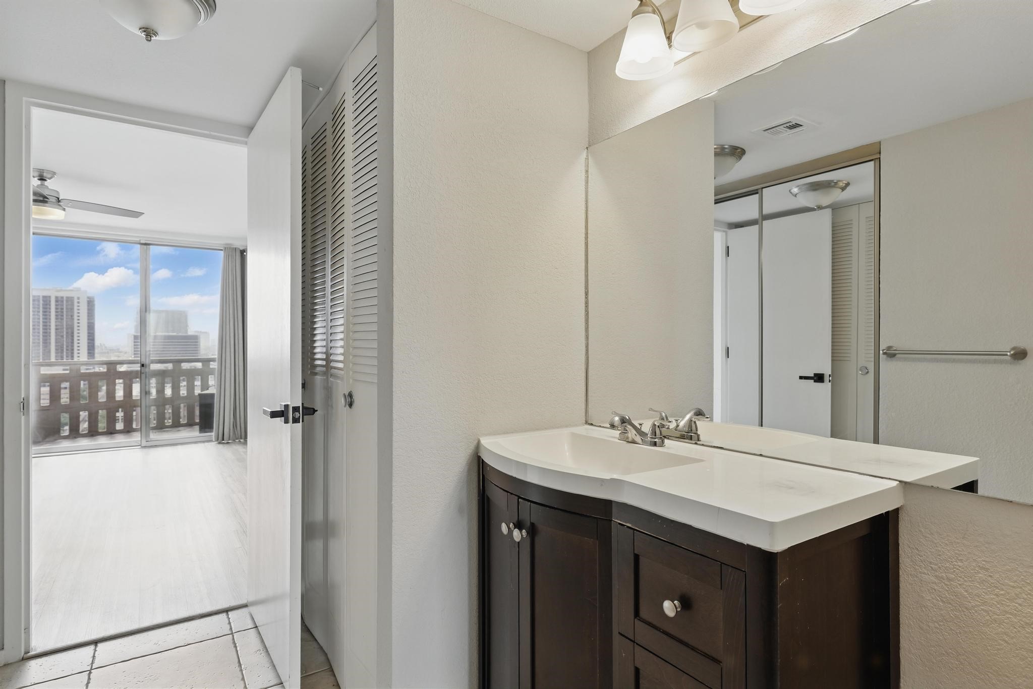 2016 Main Street, Unit 1502 Houston, TX 77002 - Photo 7 of 20 a bathroom with a sink and a mirror