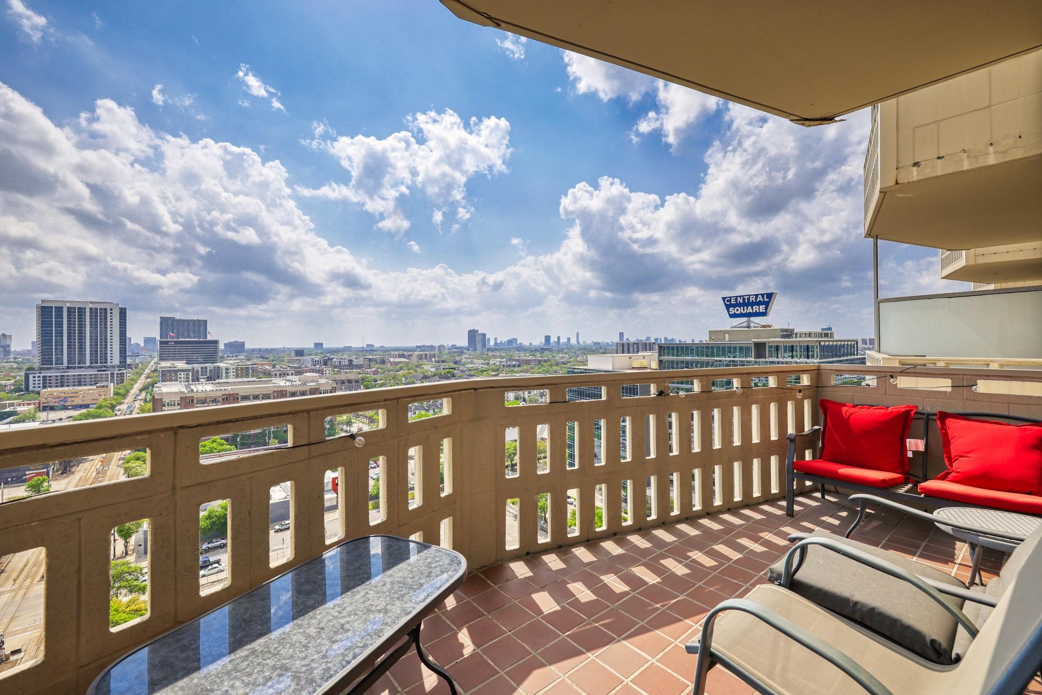 2016 Main Street, Unit 1502 Houston, TX 77002 - Photo 8 of 20 a view of a balcony with wooden chairs