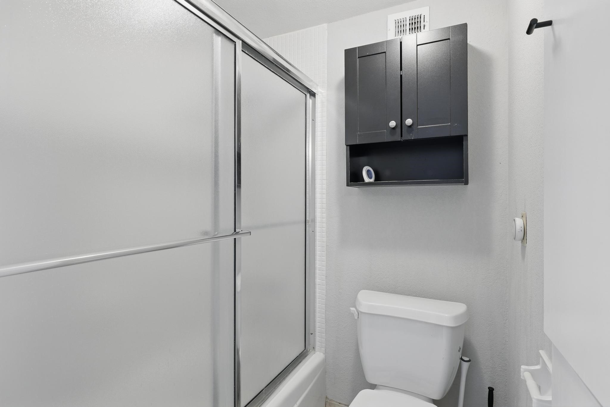 2016 Main Street, Unit 1502 Houston, TX 77002 - Photo 10 of 20 a bathroom with a sink a toilet and shower