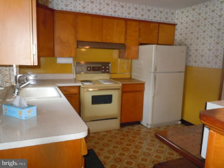 168 South Pleasantview Road Pottstown, PA 19464 - Photo 4 of 13 a kitchen with a refrigerator sink and stove