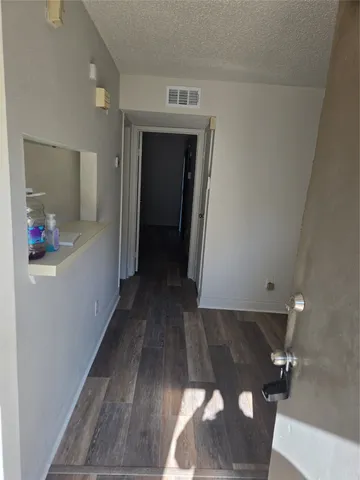 a view of hallway with wooden floor