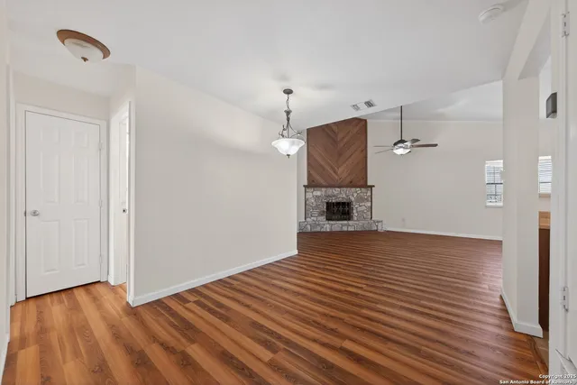 a view of empty room with wooden floor