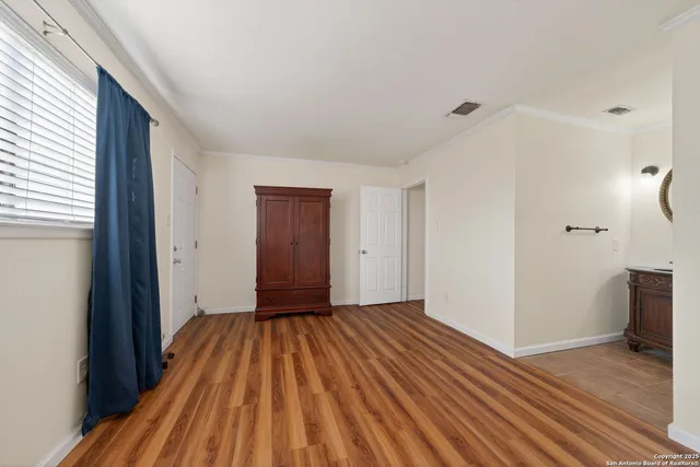 a view of a room with wooden floor