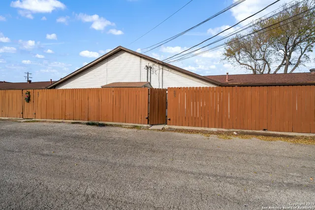 a view of an empty room with a wooden fence