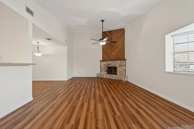 a view of empty room with wooden floor