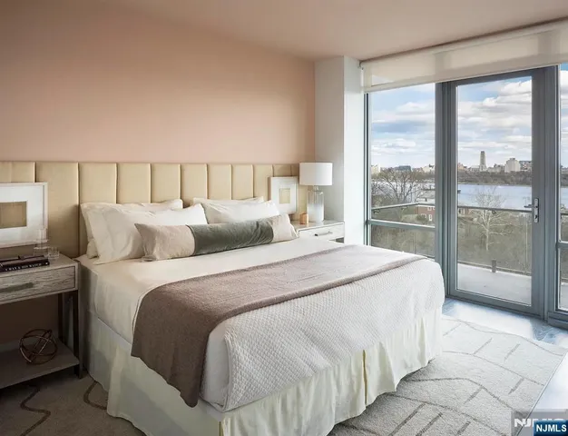 a large bed sitting in a bedroom next to a window
