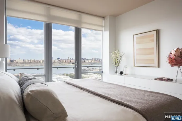 a bedroom with a large bed and a large window